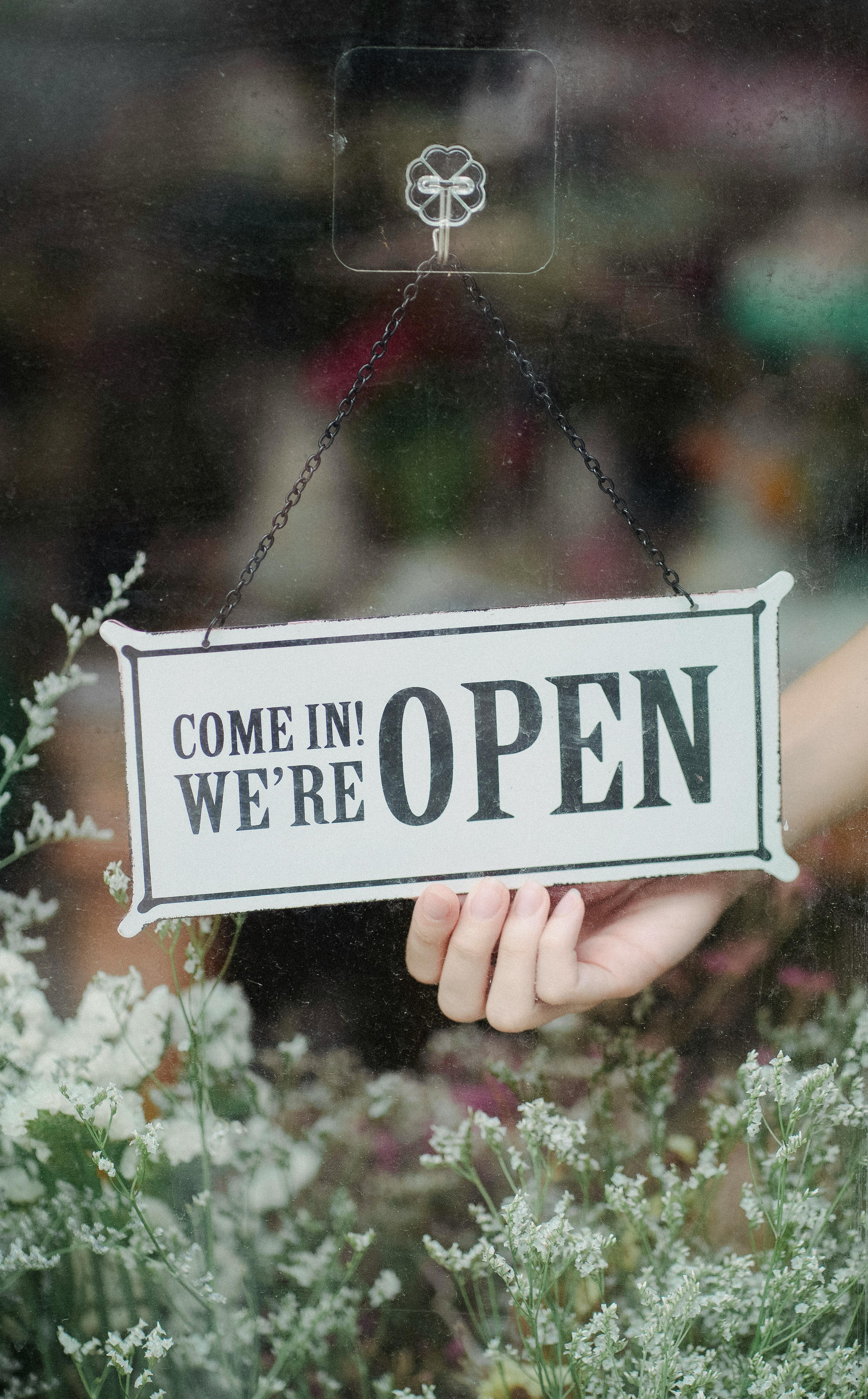 Shop sign displaying the words COME IN! WE'RE OPEN